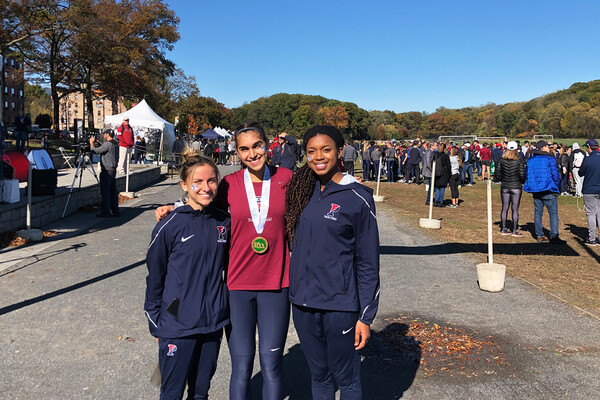 From left, Ariana Gardizy, Maddie Villalba, and Nia Akins of the Penn women’s cross country team stand together at the Ivy Heps in the Bronx.  