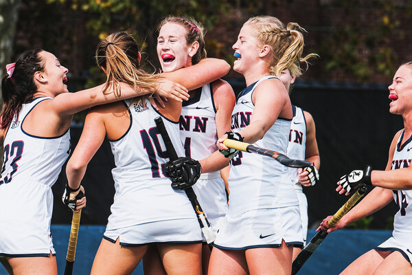Facing Brown in Providence, field hockey team members hug each other and celebrate.