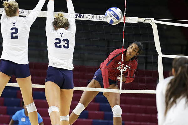 Freshman Autumn Leak of the volleyball team serves the ball against Yale at the Palestra.