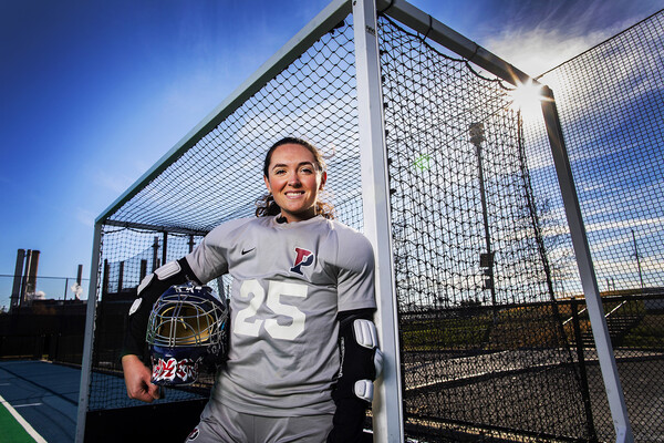 Ava Rosati, a goalie on the field hockey team, poses in her goalie pads in a goal at Vagelos Field.