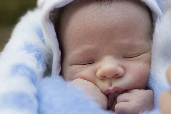 closeup of newborn face wrapped in a blanket