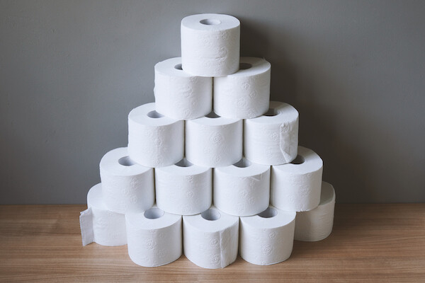 pyramid of multiple rolls of toilet paper, implying hoarding in crisis