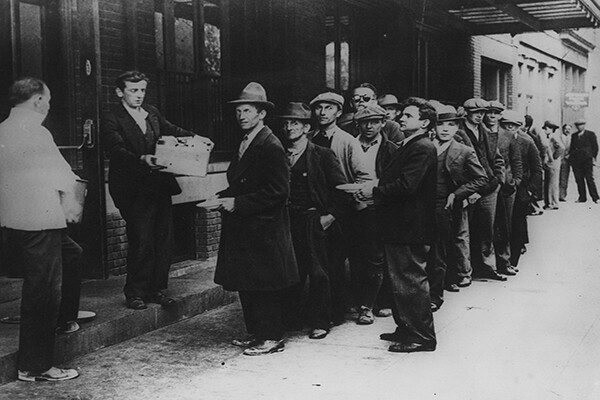 A long line of people waiting to in a bread line in New York City during the Great Depression in 1932