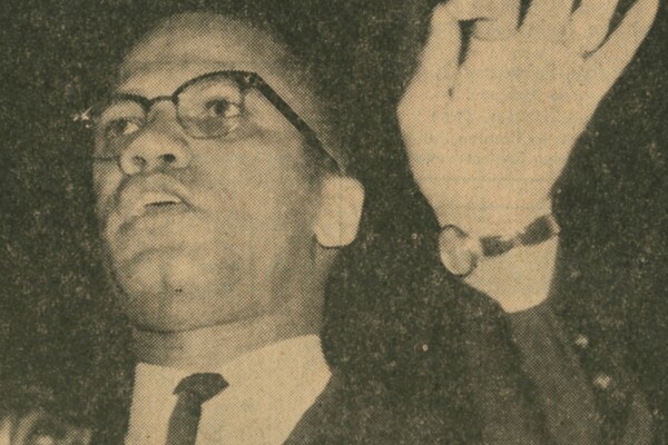 Gesturing with his hand, Malcolm X speaks at Irvine Auditorium in January of 1963.