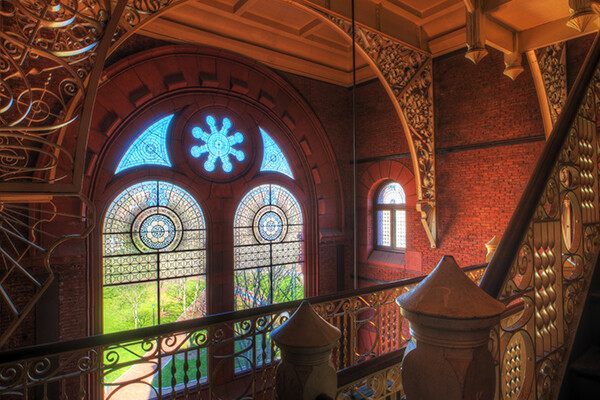 Interior of Fisher Fine Arts building, looking out the window to Locust Walk at the landing of the indoor staircase