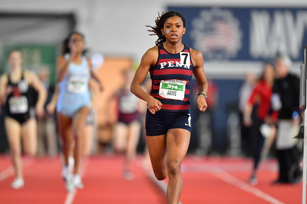Nia Akins finishes in first place at an indoor track meet.