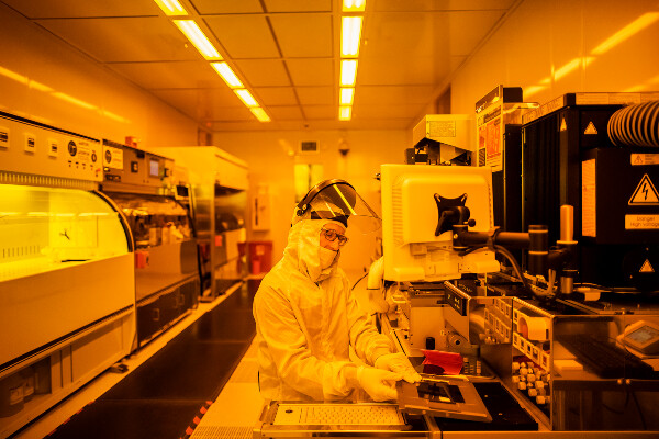 a person wearing protective gear works in a laboratory