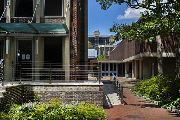 Facade of School of Social Policy & Practice building in the sunshine.