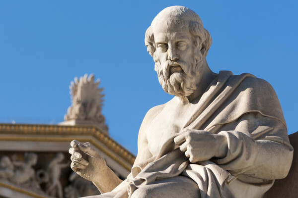 Statue of Plato against blue sky