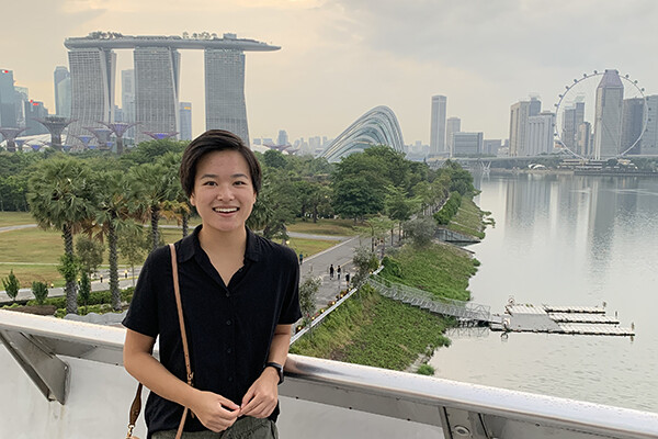 Jackie Shi stands in front of Marina Bay Sands in Singapore.