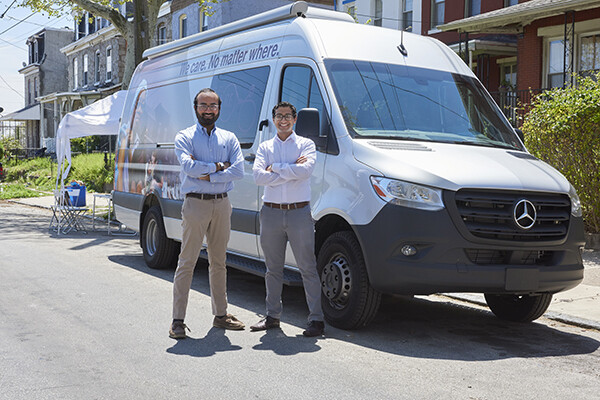 Santosh Nori and Jay Shah in front of medical van