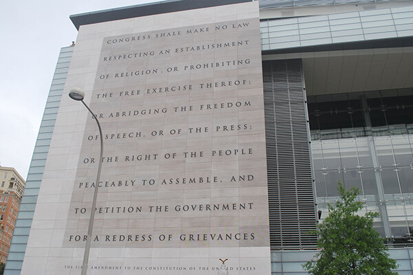 Text of the first amendment displayed on the outer wall of a building.