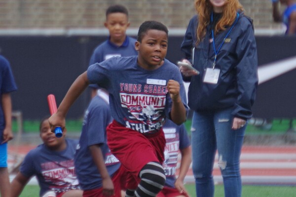 At Franklin Field, a student from West Philadelphia runs with a baton during a track & field practice.