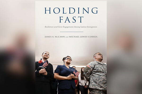 Book cover shows three people, one on the left holding a flag, one in the middle wearing glasses and one on the right wearing U.S. military fatigues.