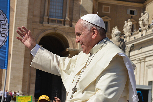 Pope Francis waving outdoors
