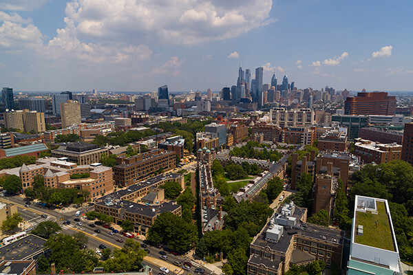 Aerial view of Penn campus and Philadelphia skyline in daylight.