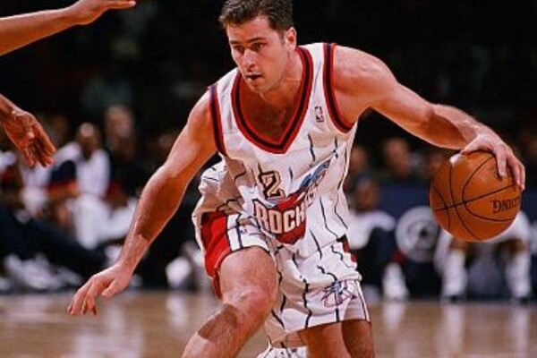 Matt Maloney makes a move with the ball on the basketball court while playing for the Houston Rockets.