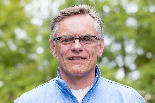 A close-up of a person standing outside. 