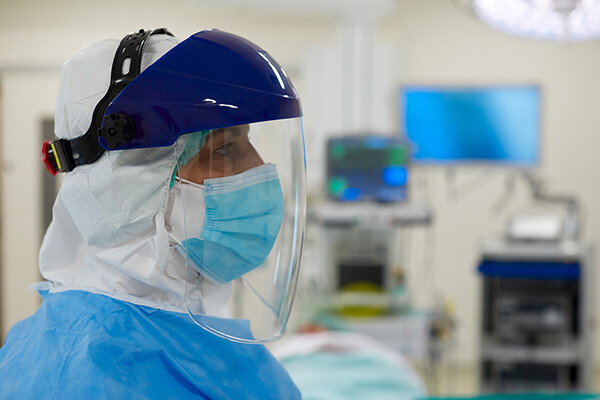 person wearing full PPE in a hospital.