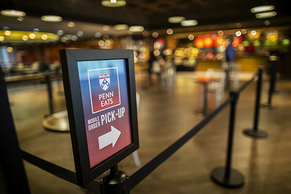 Wayfinding sign at beginning of Penn Eats pickup area.