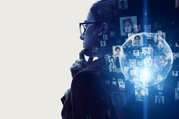 Stock image of a person staring out the window, with greyed out images of other people illuminated as if the first person is thinking about them.