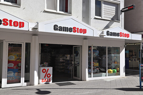 Outside entrance of a GameStop storefront in daylight.