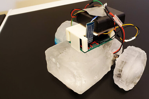 A robot made of blocks of ice on a table.