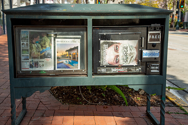 Newsstand featuring three publications, two of which are covid-related.