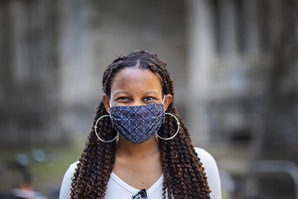 Person smiling while wearing a face mask on Penn’s campus