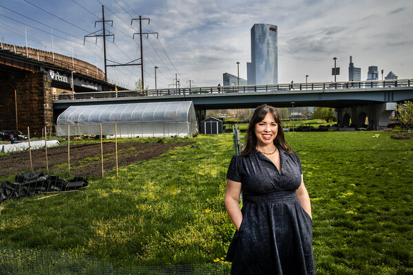 Nina Morris against the backdrop of an urban farm