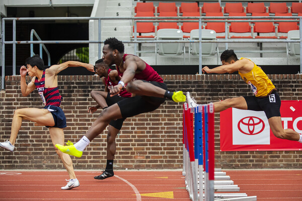 Runners jump over the hurdles at the Philadelphia Metropolitan Collegiate Invitational at Franklin Field on April 24.