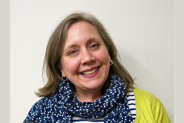 Julie Nelson Davis smiles for portrait outside her office