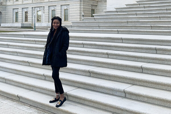 student standing on marble steps