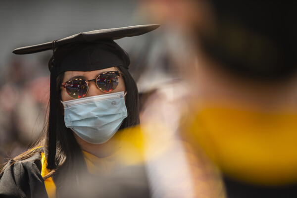 graduate close up with sunglasses and yellow color