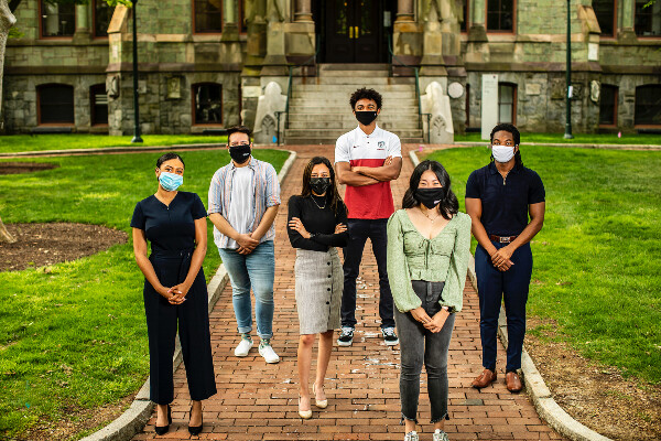 six students standing outside with masks on