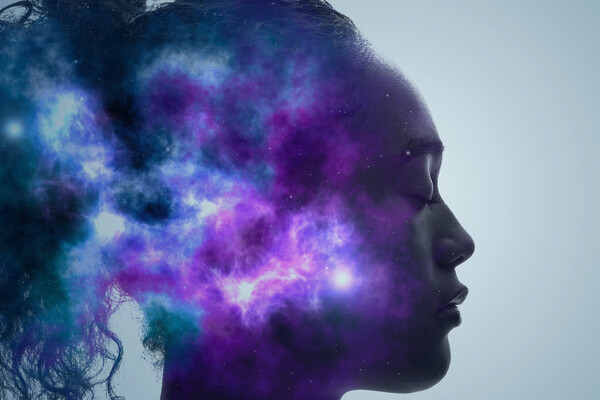 A composite image that supposed to be looking inside the mind of the person pictured. In the mind it shows blue and purple coloration, with specks of light breaking through.