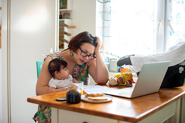 Woman sits at a desk with a baby