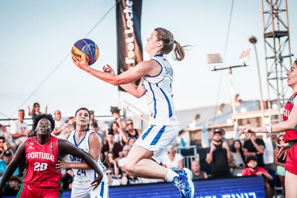 Playing for Israel against Portugal, Alyssa Baron hangs in the air and prepares to lay the ball in the net.