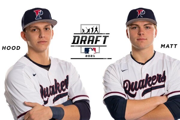 Wearing their white Penn jerseys, Josh Hood, left, and Peter Matt stand with their arms folded, against a white background.