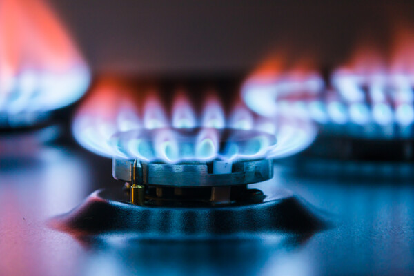 a close-up of a blue flame of methane on a natural gas burner
