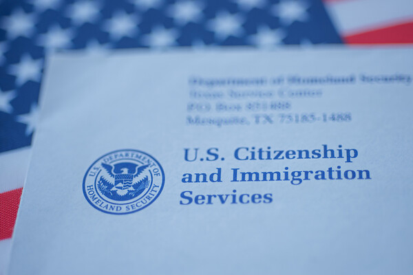 paperwork for citizenship and immigration with U.S. flag
