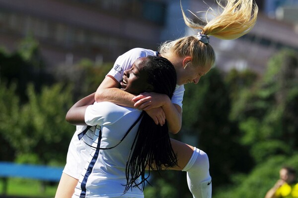At Rhodes Field against Rice, Janae Stewart lifts and hugs her teammate in celebration.