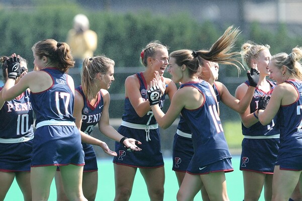 Members of the field hockey team high-five each other before a game.