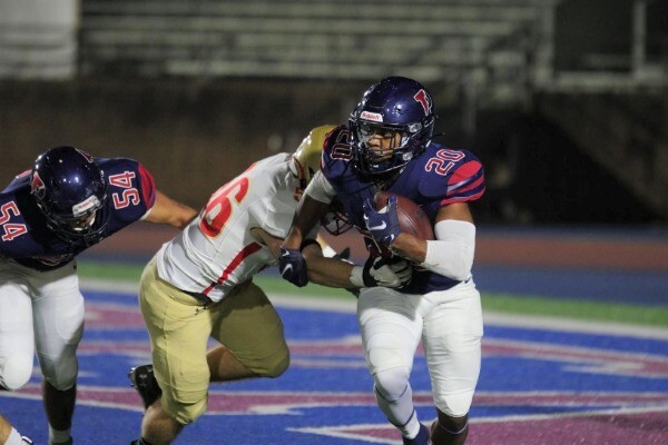 At Franklin Field, Laquan McKever breaks a tackle near the endzone while running with the ball.