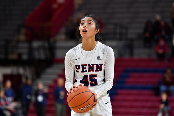 Wearing her white Penn jersey, Kayla Padilla of the women's basketball team prepares to shoot a foul shot at the Palestra.