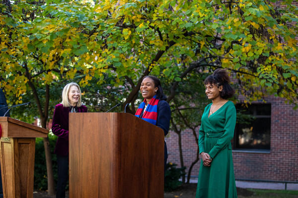 Gutmann, Laurore, and Lowery-Williams smile at podium