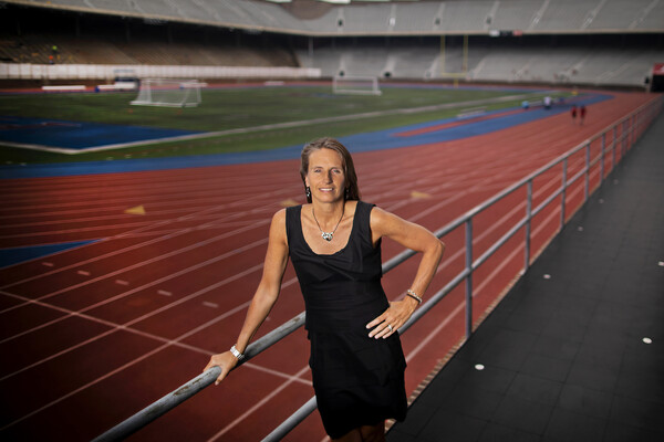 At Franklin Field, Alanna Shanahan stands in the bleachers with her hand on the top railing.