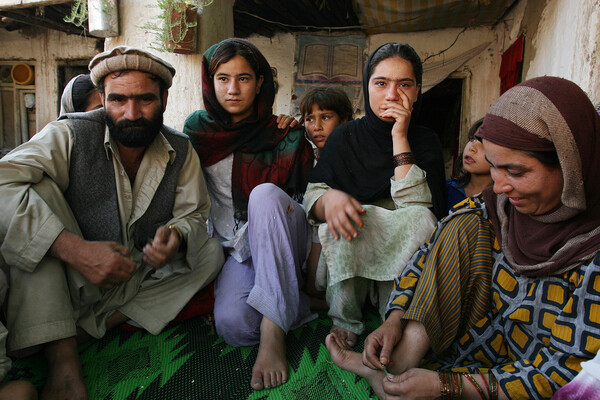 Nazir Ahmad, his two teenage daughters, and wife in Afghanistan.