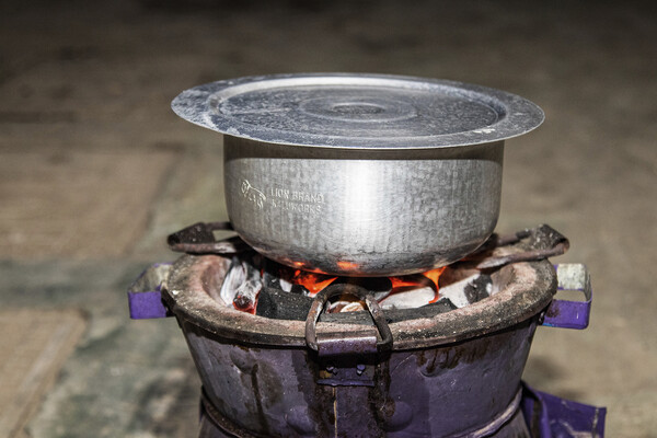 A charcoal-burning metal cookstove.