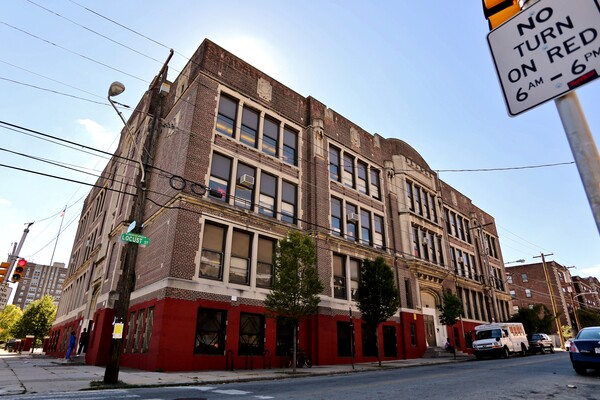 Exterior of the Lea School with Locust street sign on left and No Turn on Red Sign on right